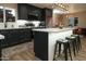 Modern kitchen features dark cabinetry, stainless appliances, white countertops, and stylish island with bar stool seating at 236 E Minton Dr, Tempe, AZ 85282