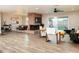 Spacious living room with a brick fireplace, wood flooring, and backyard access through sliding glass doors at 236 E Minton Dr, Tempe, AZ 85282