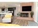 Bright living area showcasing a fireplace, modern furniture, and an open layout to the kitchen and dining spaces at 236 E Minton Dr, Tempe, AZ 85282