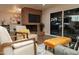 Inviting living room featuring a brick fireplace, modern seating, and ample natural light from large windows at 236 E Minton Dr, Tempe, AZ 85282