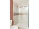 Stylish shower with glass doors, tan tile and brushed gold fixtures at 236 E Minton Dr, Tempe, AZ 85282