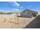 View of the home's backyard showcasing desert landscaping and contemporary architecture at 25471 W Fraktur Rd, Buckeye, AZ 85326