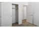 Bright bedroom featuring an open closet with sliding doors and adjacent room with neutral color palette at 25471 W Fraktur Rd, Buckeye, AZ 85326