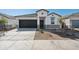 Charming single-story home with a modern facade, dark garage door, and well-maintained landscaping at 25471 W Fraktur Rd, Buckeye, AZ 85326