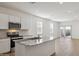 Modern kitchen with granite countertops, stainless steel appliances, and white cabinets at 25471 W Fraktur Rd, Buckeye, AZ 85326