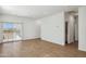 Bright living room with wood-look tile floors and sliding glass doors to let in natural light at 25471 W Fraktur Rd, Buckeye, AZ 85326