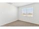 Bright bedroom features neutral carpet and a window with blinds, offering comfort and privacy at 25477 W Fraktur Rd, Buckeye, AZ 85326