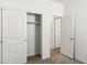 Bedroom featuring a closet with sliding doors and an open doorway, offering ample storage at 25477 W Fraktur Rd, Buckeye, AZ 85326