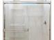 This bathroom features a modern glass shower door and marble-like wall tiling at 25477 W Fraktur Rd, Buckeye, AZ 85326