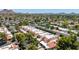 Townhome aerial view showcasing a well-maintained neighborhood with mature trees, street parking, and scenic mountain views at 26 E Coral Gables Dr, Phoenix, AZ 85022