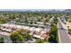 Townhome aerial view showcasing a well-maintained neighborhood with mature trees, street parking, and scenic mountain views at 26 E Coral Gables Dr, Phoenix, AZ 85022