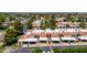Exterior aerial view of townhomes featuring a mix of red-tiled and white roofs, surrounded by mature trees at 26 E Coral Gables Dr, Phoenix, AZ 85022