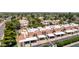Exterior aerial view of townhomes featuring a mix of red-tiled and white roofs, surrounded by mature trees at 26 E Coral Gables Dr, Phoenix, AZ 85022