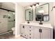 Bathroom featuring a double vanity, modern fixtures, and a glass-enclosed shower at 26 E Coral Gables Dr, Phoenix, AZ 85022