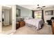 Cozy bedroom features a ceiling fan, window, and closet for comfort and convenience at 26 E Coral Gables Dr, Phoenix, AZ 85022