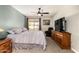 Bright bedroom with a ceiling fan, large window, and comfortable furniture at 26 E Coral Gables Dr, Phoenix, AZ 85022