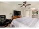 Comfortable bedroom with ceiling fan, television, and relaxing chair at 26 E Coral Gables Dr, Phoenix, AZ 85022