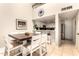 Bright dining area connects to the kitchen with a breakfast bar and modern appliances at 26 E Coral Gables Dr, Phoenix, AZ 85022