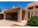 Inviting home with desert landscaping, a covered carport, and shade coverings on the windows at 26 E Coral Gables Dr, Phoenix, AZ 85022