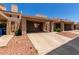 Exterior view of the charming townhouse with desert landscaping and covered parking at 26 E Coral Gables Dr, Phoenix, AZ 85022