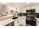 Well-appointed kitchen with stainless steel appliances and views of the dining and living spaces at 26 E Coral Gables Dr, Phoenix, AZ 85022