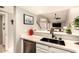 Updated kitchen with stainless steel appliances, white cabinetry, and a view to the living area at 26 E Coral Gables Dr, Phoenix, AZ 85022