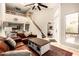 Open-concept living room with staircase, view to the kitchen, and access to a bedroom offers great flow at 26 E Coral Gables Dr, Phoenix, AZ 85022