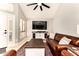 Inviting living room features a leather sofa, ceiling fan, and neutral decor for comfortable living at 26 E Coral Gables Dr, Phoenix, AZ 85022