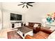 Comfortable living room showcases a leather sofa, stylish rug, and entertainment center at 26 E Coral Gables Dr, Phoenix, AZ 85022