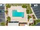 Aerial view showcases sparkling community pool, loungers, spa, and nearby parking at 26 E Coral Gables Dr, Phoenix, AZ 85022