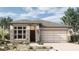 Charming single-Gathering home featuring a stone facade and a two-car garage in a landscaped yard at 26031 S 228Th Pl, Queen Creek, AZ 85142