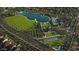 Bird's-eye view of the community, highlighting a large lake, park, clubhouse, pool and walking trails for outdoor activities at 36049 N Barrel Aged Dr, San Tan Valley, AZ 85140