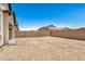 Spacious dirt backyard featuring block fencing with a blue sky background at 3629 E Rochelle Cir, Mesa, AZ 85213