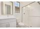Bright bathroom features a glass door shower, toilet, sink with mirror and a window offering plenty of natural light at 3629 E Rochelle Cir, Mesa, AZ 85213