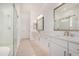 Bright bathroom featuring dual vanities, quartz countertops, and a frameless glass shower at 3629 E Rochelle Cir, Mesa, AZ 85213