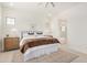 Cozy bedroom with a walk-in bathroom featuring a large bed, neutral rug and natural light at 3629 E Rochelle Cir, Mesa, AZ 85213