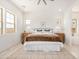 Bright bedroom with a walk-in bathroom featuring a large bed, neutral rug, and multiple windows at 3629 E Rochelle Cir, Mesa, AZ 85213