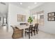 Inviting dining room features contemporary decor, wood-look tile flooring, and bright natural light at 3629 E Rochelle Cir, Mesa, AZ 85213