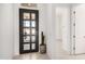 Bright entryway featuring a modern black door, sleek tile flooring, and a decorative cactus at 3629 E Rochelle Cir, Mesa, AZ 85213