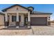 Charming home with a well-manicured front yard, covered porch, and a convenient two-car garage at 3629 E Rochelle Cir, Mesa, AZ 85213