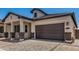 Home exterior features a two-car garage, a well-maintained lawn and professional landscaping at 3629 E Rochelle Cir, Mesa, AZ 85213