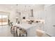 Bright kitchen features bar seating, stainless appliances, and white cabinetry, perfect for modern living at 3629 E Rochelle Cir, Mesa, AZ 85213