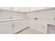 Clean laundry room with white cabinets, modern sink, and washing machine hook-ups offer functionality and style at 3629 E Rochelle Cir, Mesa, AZ 85213