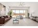 Spacious living area with a ceiling fan, neutral decor, modern sofa and large windows for natural light at 3629 E Rochelle Cir, Mesa, AZ 85213