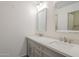 Updated bathroom features a double vanity with gray cabinets, white countertop and two mirrors at 3811 S Mill Ave, Tempe, AZ 85282