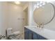 Updated bathroom features a blue vanity with white countertop, decorative tile floor, and round mirror at 3811 S Mill Ave, Tempe, AZ 85282