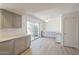 Open kitchen and eating area offers gray cabinets, counter space and sliding door access to the outside at 3811 S Mill Ave, Tempe, AZ 85282