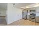 Updated kitchen features stainless steel appliances and wood-look floors, plus access to a large closet at 3811 S Mill Ave, Tempe, AZ 85282