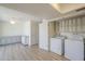 Modern laundry room equipped with storage cabinets, a ceiling fan and side-by-side washer and dryer at 3811 S Mill Ave, Tempe, AZ 85282