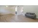 Open living room offers wood-look floors and access to a bathroom through an arched doorway at 3811 S Mill Ave, Tempe, AZ 85282